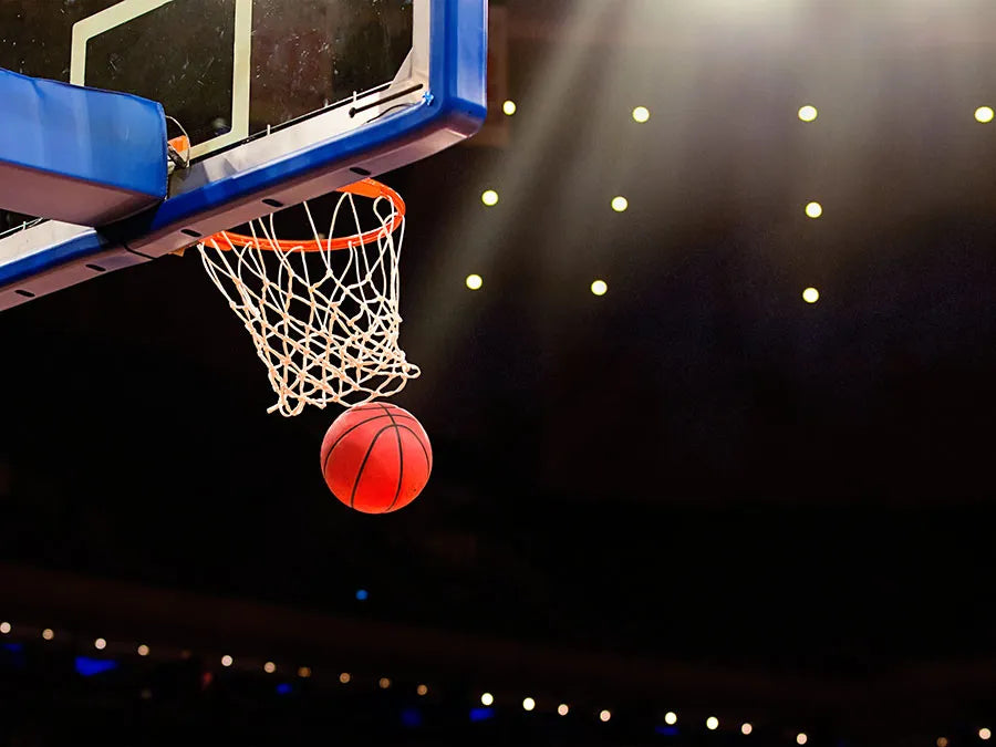 This is an image of a basketball going through a hoop.